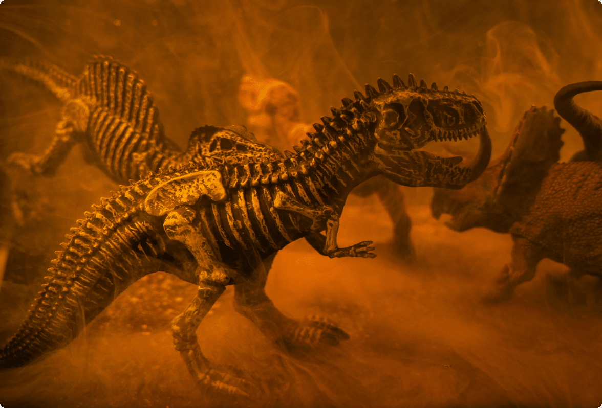 A photo of dinosaur skeletons in an orange mist